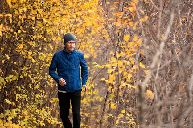 Male running on trail in forest