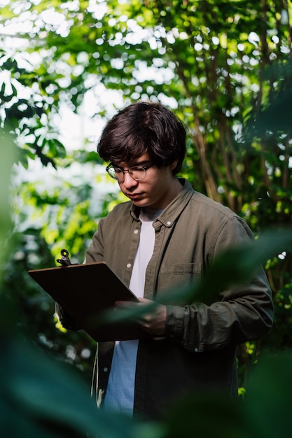 Free photo male scientist carefully studies his data