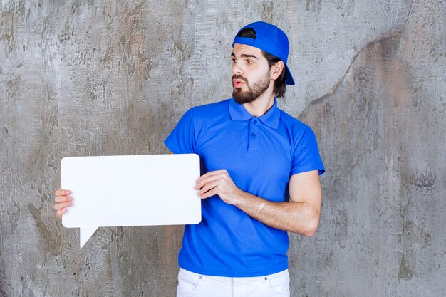 Male service agent in blue uniform holding a rectangle info board.