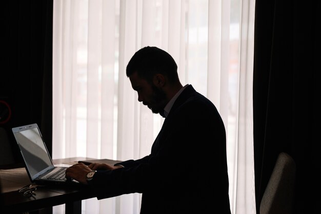 Male silhouette with laptop