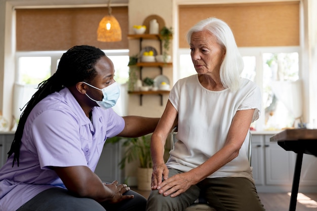 male social worker taking care of an old woman