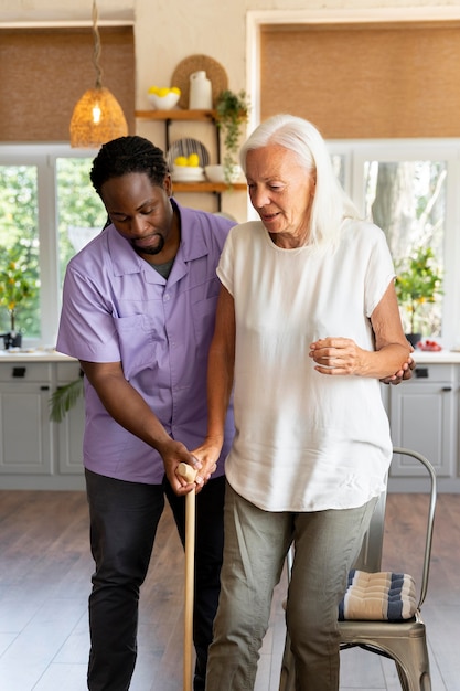 Free photo male social worker taking care of an old woman