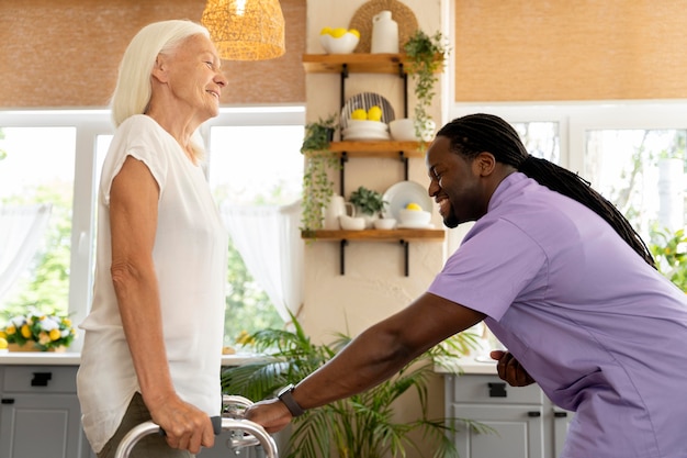 Free photo male social worker taking care of an old woman