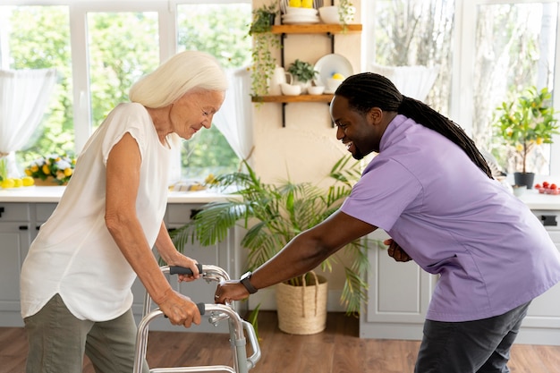 Free photo male social worker taking care of an old woman