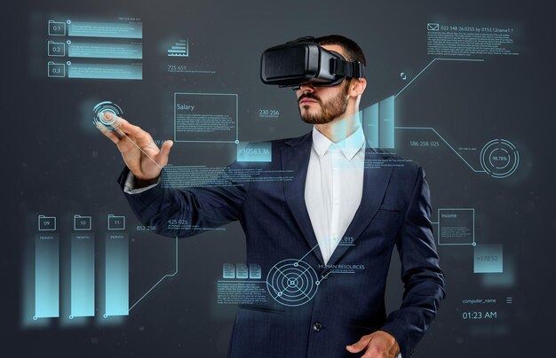 Male in a suit with virtual reality glasses on his head working in virtual financial world.