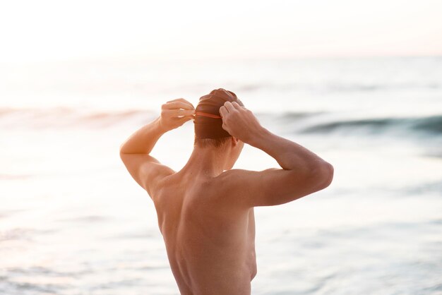 Male swimmer wearing goggles and cap