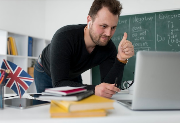 Male teacher doing an english lesson online for his students