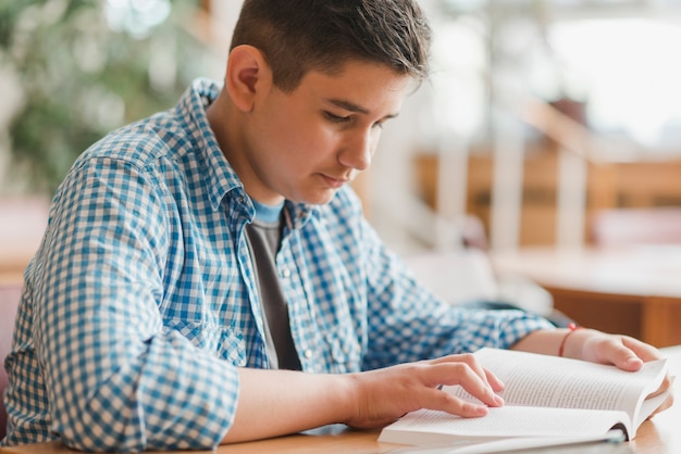 Male teenager enjoying reading
