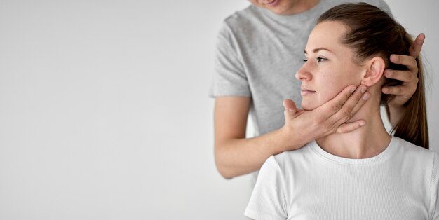 Male therapist undergoing physical therapy with female patient