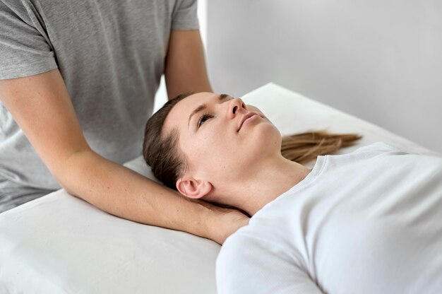 Male therapist undergoing physical therapy with female patient