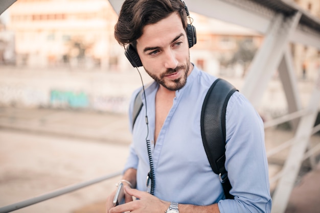 Male tourist listening to music on headphone