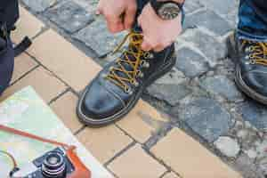 Free photo male tourist tightening shoes