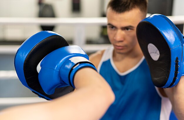 Male trainer teaching boxing