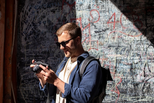 Male traveler with a camera in a local place