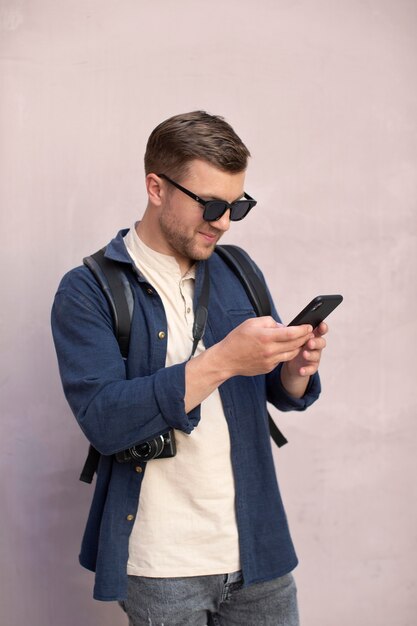 Male traveler with a camera outdoors