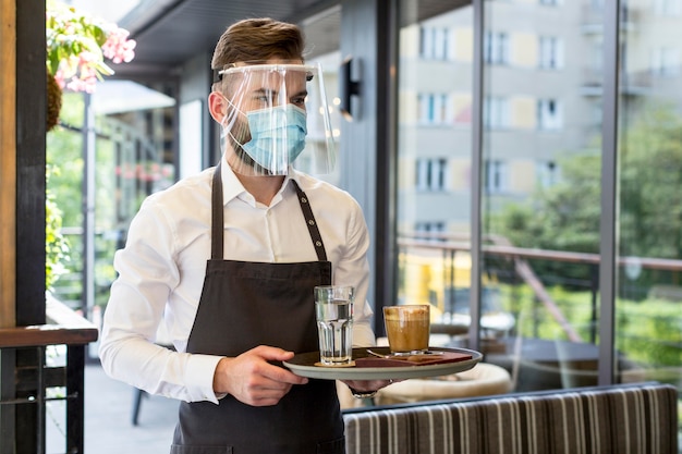 Male waiter wearing mask