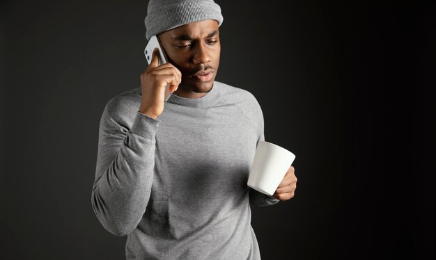 Male wearing cap talking on phone