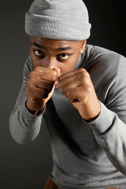 Free photo male wearing cap with fists clenched