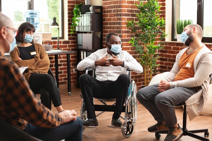 Free Photo male wheelchair user speaking at therapy
