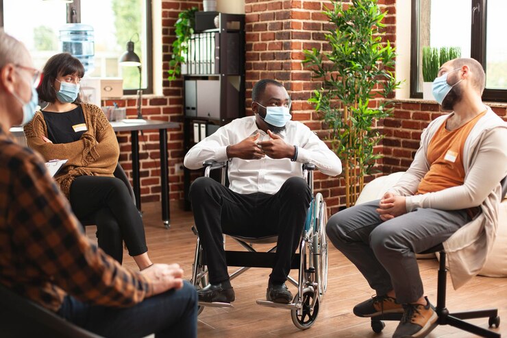 Free Photo male wheelchair user speaking at therapy