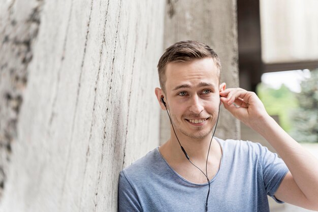 Male with earphones listening music