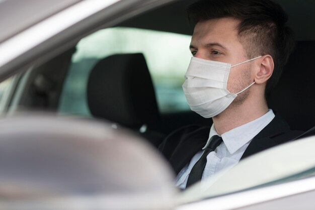 Male with mask driving