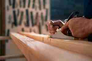 Free photo male wood worker in his shop working with tools and equipment