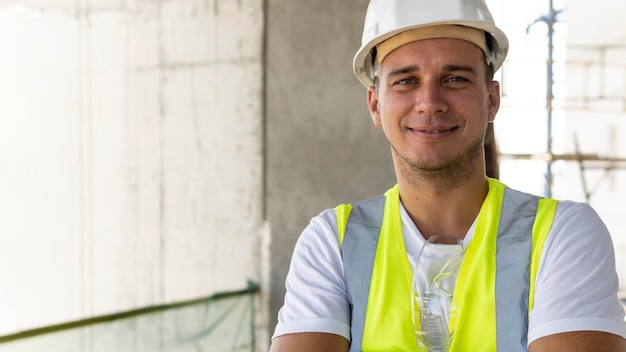 Male worker in construction wearing protection gear