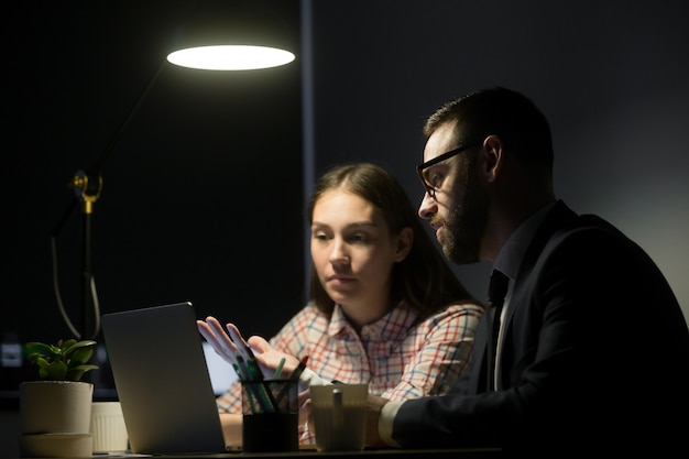 Male worker explaining marketing plans to female coworker