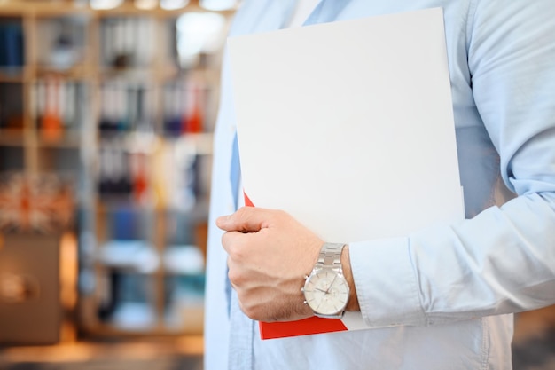 Free photo male worker holding a notebook in an office