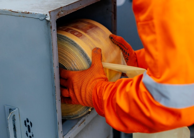 Male worker in uniform and protective gloves