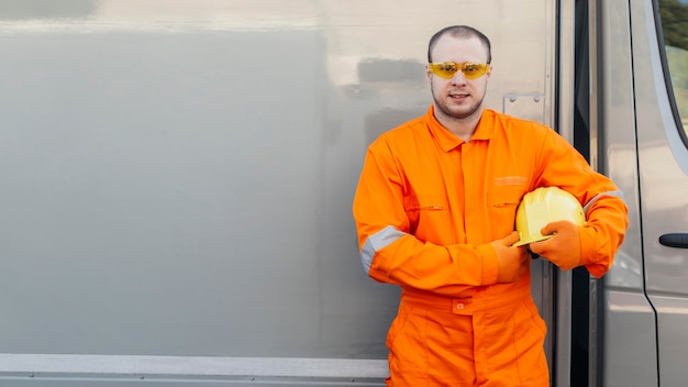 Free photo male worker in uniform with protective glasses and copy space