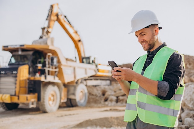 Male worker with bulldozer in sand quarry