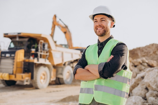 Male worker with bulldozer in sand quarry