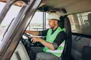 Free photo male worker with bulldozer in sand quarry