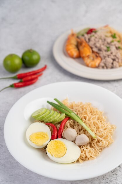 Mama with boiled eggs in a white dish.