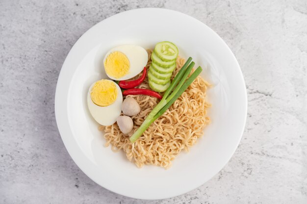 Mama with boiled eggs in a white dish.