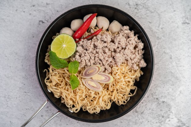 Mama with minced pork in a frying pan.