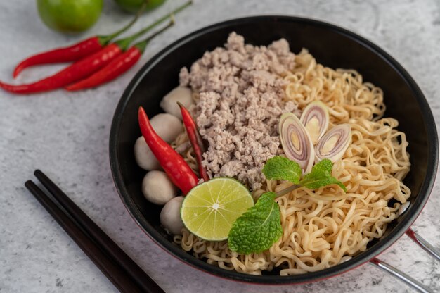 Mama with minced pork in a frying pan.