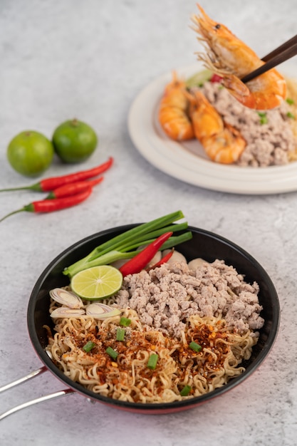 Mama with minced pork in a frying pan.