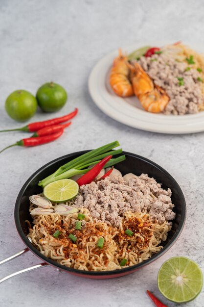 Mama with minced pork in a frying pan.