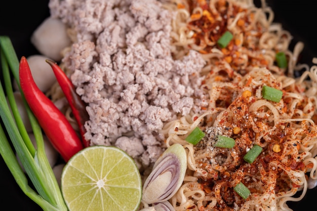 Mama with minced pork in a frying pan.