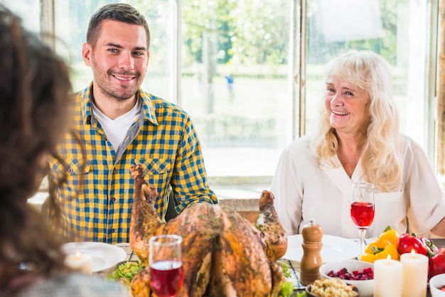 Man and aged smiling woman sitting at table