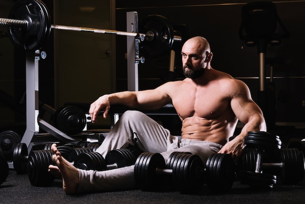 Man amidst dumbbells