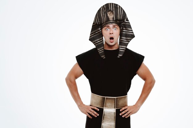 Man in ancient egyptian costume being amzed and surprised on white