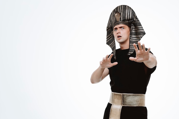 Man in ancient egyptian costume worried making stop gesture with hands on white