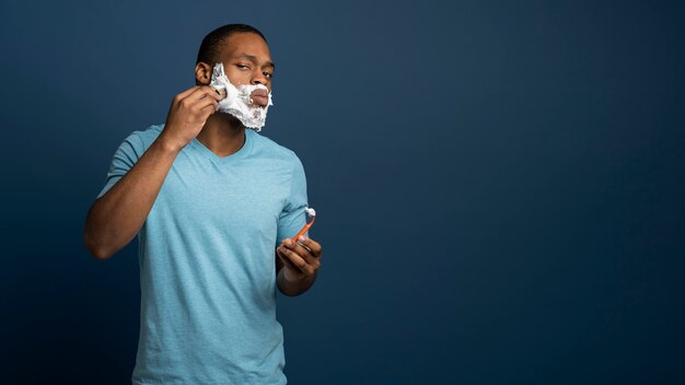 Man applying shaving cream medium shot