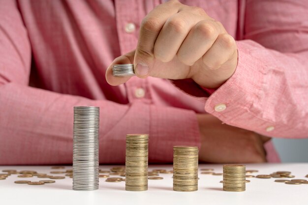 Man arranging stack of coins