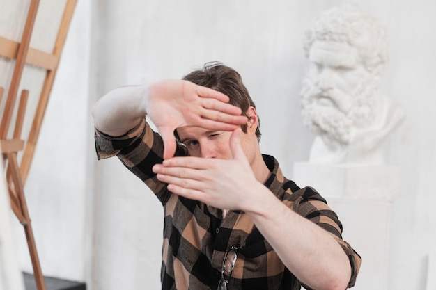 Man artist making a frame with his fingers