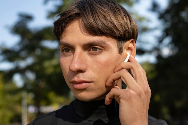Man in athletic wear and earbuds outdoors